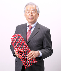 Sumio Iijima holding a molecular model representing the structure of carbon nanotubes, the nanomaterial discovered in 1991